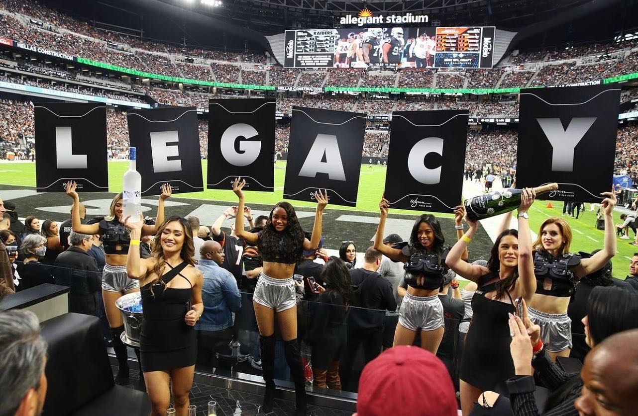 wynn field club girls holding sign